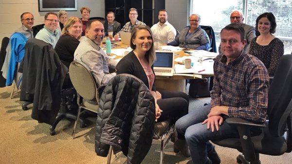 The staff and board of directors behind the BCSPI enjoy a training session in a boardroom on vancouver island.