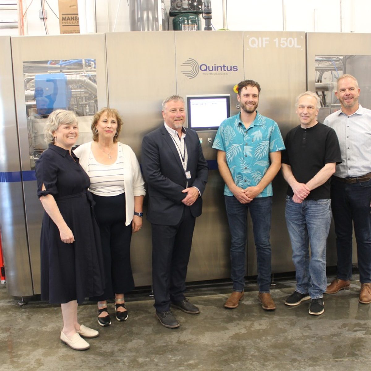 Project partners and community leaders stand alongside the new water pressure shucking machine installed as part of the expansion, supporting increased seafood processing capacity and new opportunities.